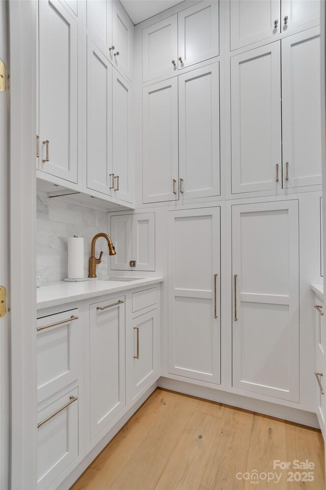 38 Thistle Ln, Fletcher, NC 28732 - detailed view of wood finished floors, decorative backsplash, and a sink