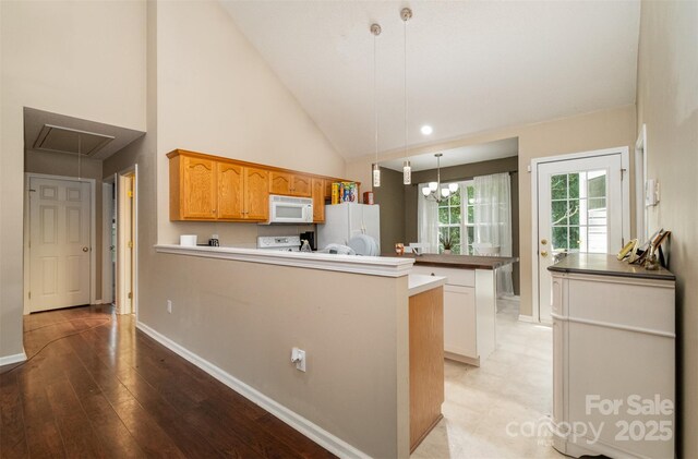 159 Pitts School Rd NW, Concord, NC 28027 - kitchen featuring white appliances, a peninsula, baseboards, pendant lighting, and high vaulted ceiling