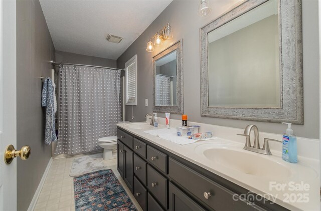 159 Pitts School Rd NW, Concord, NC 28027 - full bath featuring toilet, double vanity, tile patterned floors, baseboards, and a shower with shower curtain
