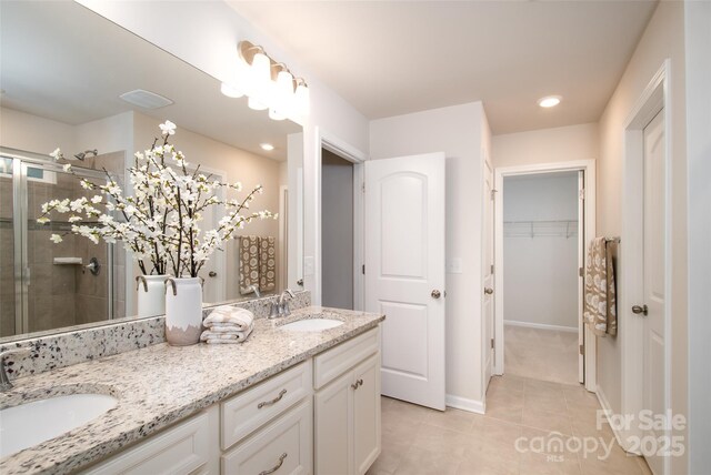 150 W Morehouse Ave, Mooresville, NC 28117 - bathroom with double vanity, a stall shower, tile patterned flooring, a spacious closet, and recessed lighting