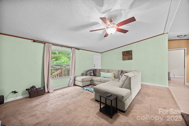 112 Cordella Rd, Candler, NC 28715 - carpeted living room featuring a ceiling fan, a textured ceiling, crown molding, baseboards, and vaulted ceiling