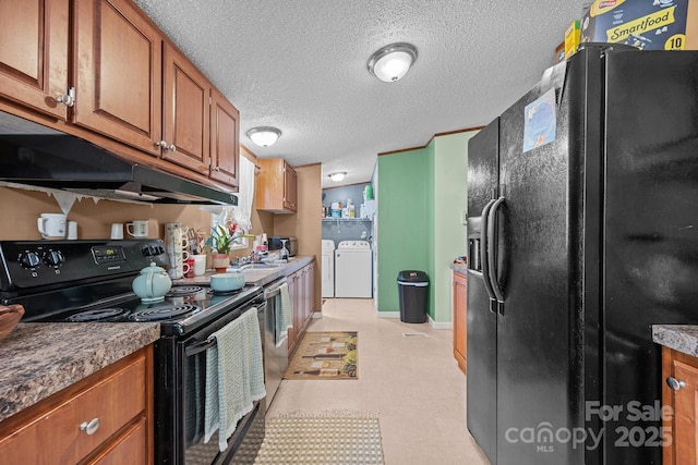 112 Cordella Rd, Candler, NC 28715 - kitchen with black appliances, separate washer and dryer, brown cabinets, a textured ceiling, and light floors