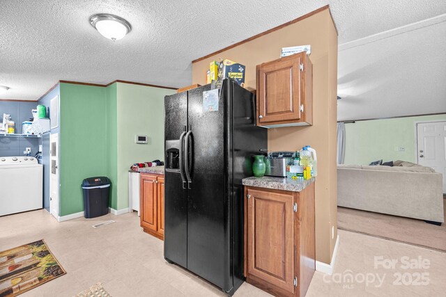 112 Cordella Rd, Candler, NC 28715 - kitchen featuring washer / clothes dryer, black fridge with ice dispenser, a textured ceiling, brown cabinets, and light countertops