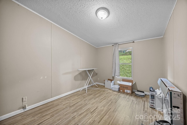 112 Cordella Rd, Candler, NC 28715 - spare room featuring wood finished floors, a textured ceiling, crown molding, and baseboards