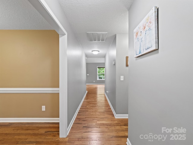 5369 Concord Rd, York, SC 29745 - corridor featuring wood finished floors, a textured ceiling, and baseboards