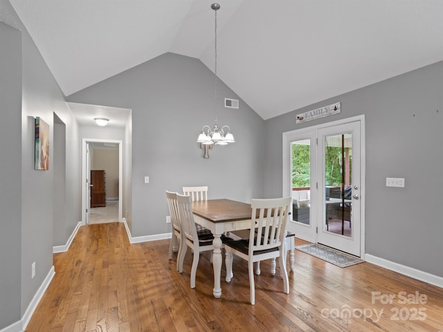 5369 Concord Rd, York, SC 29745 - dining room with vaulted ceiling, wood finished floors, a chandelier, and baseboards