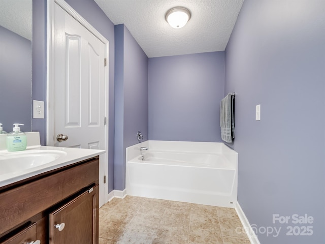 5369 Concord Rd, York, SC 29745 - full bathroom with a textured ceiling, a bath, vanity, baseboards, and tile patterned flooring
