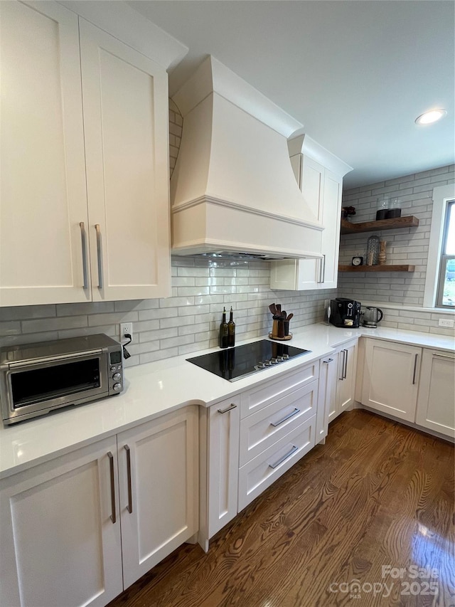 1427 Kinks Ln Unit 47, Maiden, NC 28650 - kitchen featuring premium range hood, black electric cooktop, dark wood-style flooring, tasteful backsplash, and white cabinets
