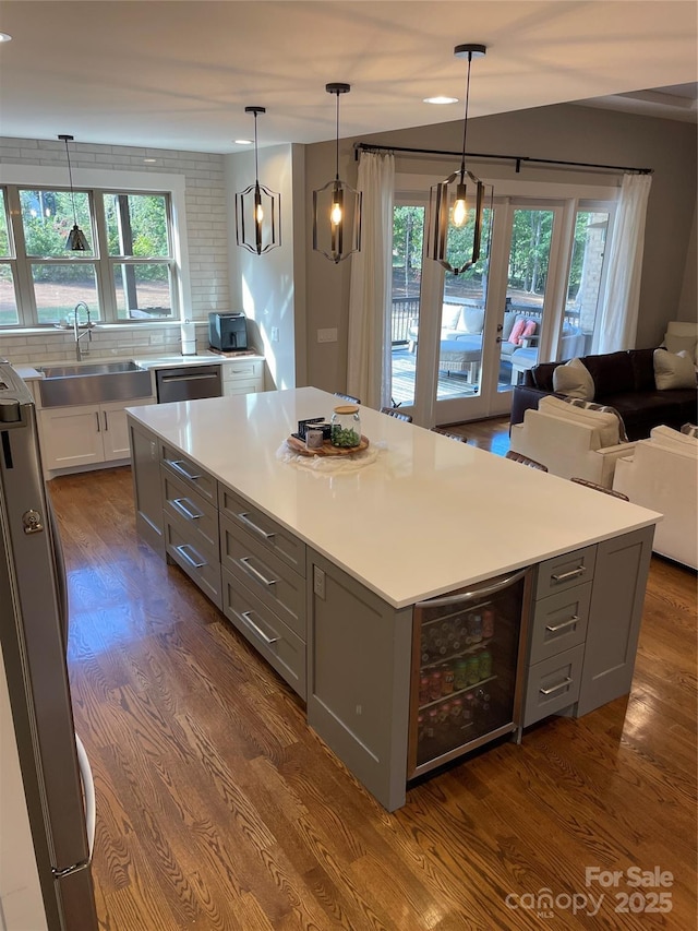 1427 Kinks Ln Unit 47, Maiden, NC 28650 - kitchen with beverage cooler, a sink, gray cabinetry, light countertops, and dark wood-style floors