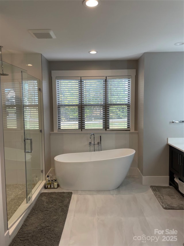 1427 Kinks Ln Unit 47, Maiden, NC 28650 - bathroom with healthy amount of natural light, a freestanding tub, a shower stall, vanity, and recessed lighting