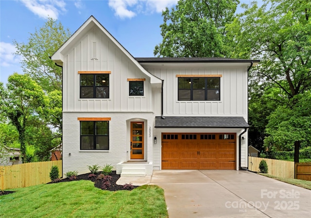 2033 Camp Greene St, Charlotte, NC 28208 - view of front of property with board and batten siding, driveway, an attached garage, and roof with shingles