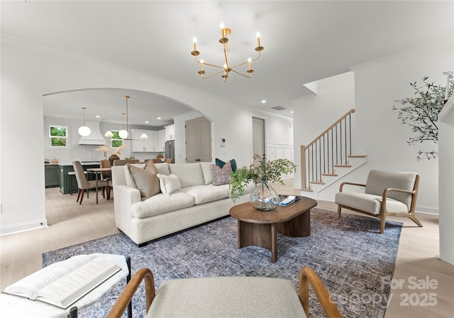 2033 Camp Greene St, Charlotte, NC 28208 - living area with arched walkways, light wood-style floors, recessed lighting, a chandelier, and stairway