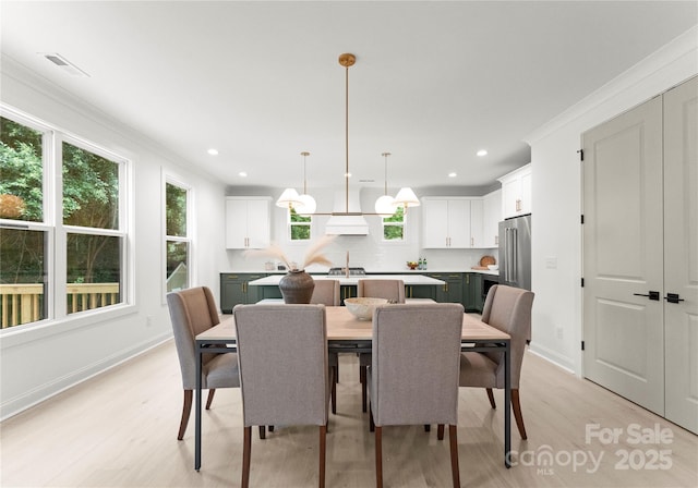 2033 Camp Greene St, Charlotte, NC 28208 - dining space featuring light wood-style floors, baseboards, recessed lighting, and crown molding