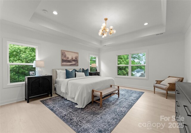 2033 Camp Greene St, Charlotte, NC 28208 - bedroom with a raised ceiling, multiple windows, a chandelier, recessed lighting, and light wood-type flooring
