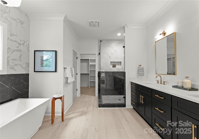 2033 Camp Greene St, Charlotte, NC 28208 - full bath with a stall shower, ornamental molding, wood finished floors, a soaking tub, and double vanity