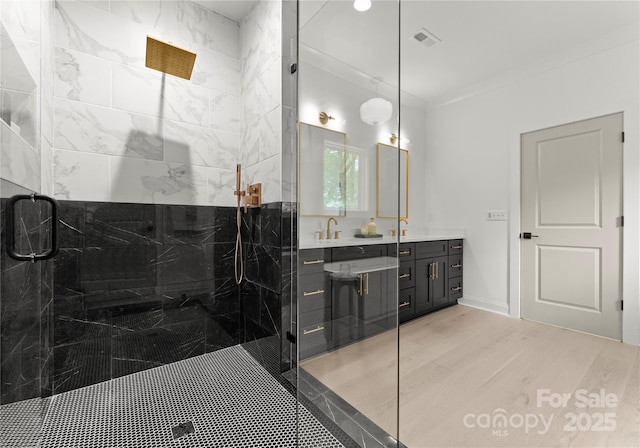 2033 Camp Greene St, Charlotte, NC 28208 - bathroom with a marble finish shower, double vanity, and wood finished floors
