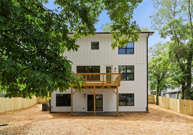 2033 Camp Greene St, Charlotte, NC 28208 - back of house featuring cooling unit, a fenced backyard, and board and batten siding