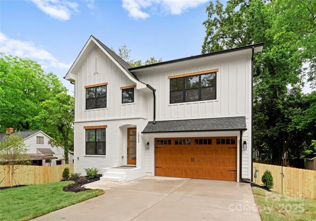 2033 Camp Greene St, Charlotte, NC 28208 - modern farmhouse style home with board and batten siding, an attached garage, driveway, and roof with shingles