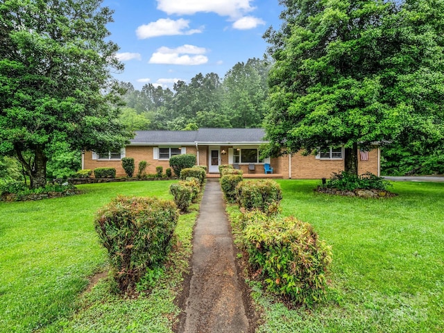 989 Mine Gap Rd, Zirconia, NC 28790 - ranch-style home featuring brick siding, a front lawn, and a porch