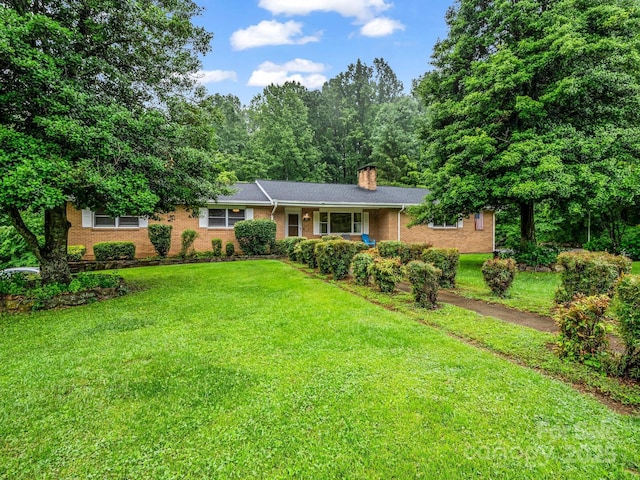 989 Mine Gap Rd, Zirconia, NC 28790 - ranch-style home with brick siding, a chimney, and a front yard