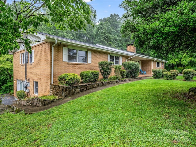 989 Mine Gap Rd, Zirconia, NC 28790 - ranch-style house with brick siding, a front yard, and a chimney