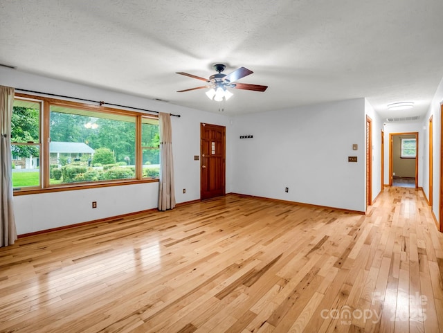 989 Mine Gap Rd, Zirconia, NC 28790 - unfurnished room with light wood finished floors, a ceiling fan, and baseboards