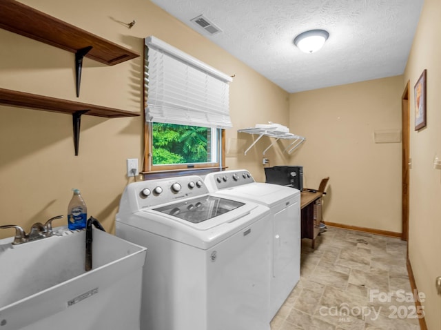 989 Mine Gap Rd, Zirconia, NC 28790 - washroom with washer and dryer, baseboards, a textured ceiling, and stone finish floors