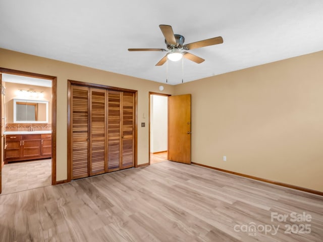 989 Mine Gap Rd, Zirconia, NC 28790 - unfurnished bedroom featuring a closet, light wood-style flooring, connected bathroom, and baseboards