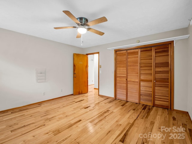989 Mine Gap Rd, Zirconia, NC 28790 - unfurnished bedroom with hardwood / wood-style floors, a closet, baseboards, and ceiling fan
