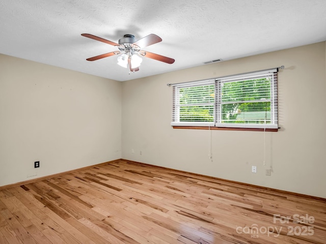 989 Mine Gap Rd, Zirconia, NC 28790 - empty room featuring light wood-type flooring, a ceiling fan, baseboards, and a textured ceiling