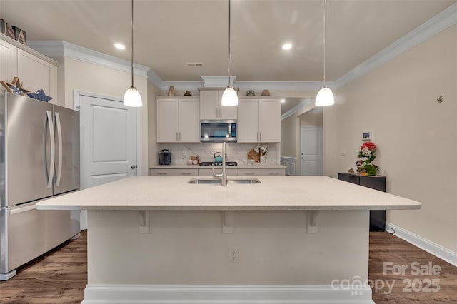 608 Latrobe Dr, Iron Station, NC 28080 - kitchen featuring stainless steel appliances, ornamental molding, a kitchen bar, decorative backsplash, and dark wood finished floors