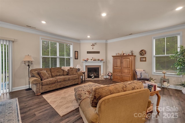 608 Latrobe Dr, Iron Station, NC 28080 - living room featuring a fireplace with flush hearth, baseboards, wood finished floors, ornamental molding, and recessed lighting