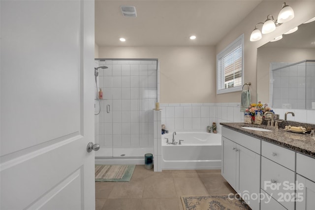 608 Latrobe Dr, Iron Station, NC 28080 - full bath with tile patterned flooring, vanity, a shower stall, a garden tub, and recessed lighting