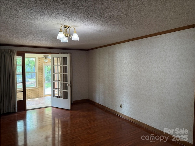 6018 Unionville Rd, Monroe, NC 28110 - empty room with ornamental molding, dark wood-style flooring, a chandelier, a textured ceiling, and baseboards