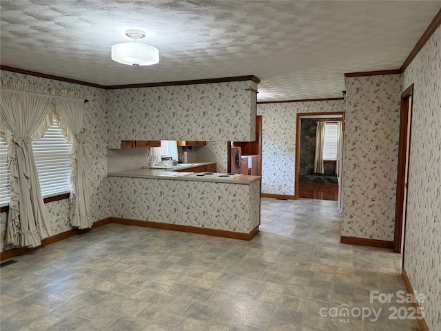 6018 Unionville Rd, Monroe, NC 28110 - kitchen featuring wallpapered walls, ornamental molding, a peninsula, baseboards, and a textured ceiling