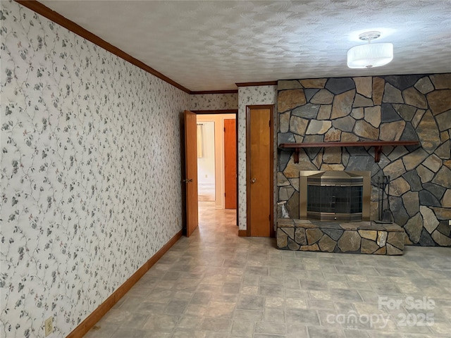 6018 Unionville Rd, Monroe, NC 28110 - unfurnished living room featuring ornamental molding, wallpapered walls, baseboards, and a stone fireplace