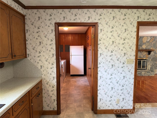 6018 Unionville Rd, Monroe, NC 28110 - kitchen with freestanding refrigerator, baseboards, ornamental molding, wallpapered walls, and light countertops