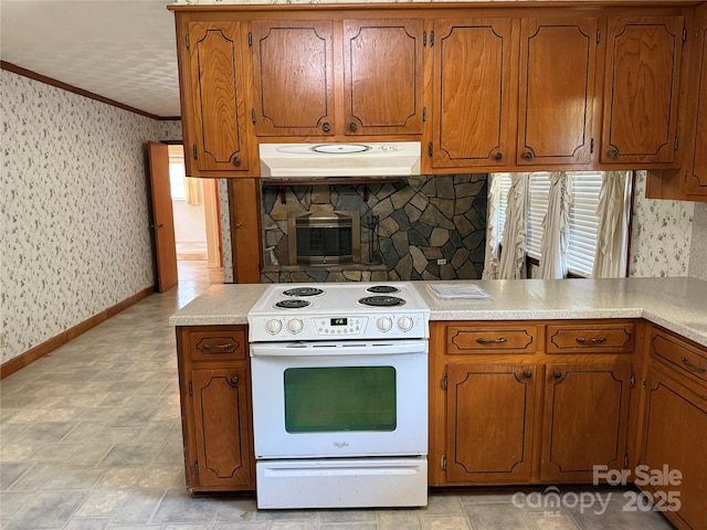 6018 Unionville Rd, Monroe, NC 28110 - kitchen with white electric range, under cabinet range hood, crown molding, wallpapered walls, and brown cabinets