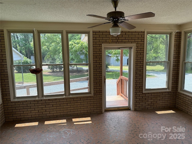 6018 Unionville Rd, Monroe, NC 28110 - empty room with brick wall, a textured ceiling, ceiling fan, and plenty of natural light