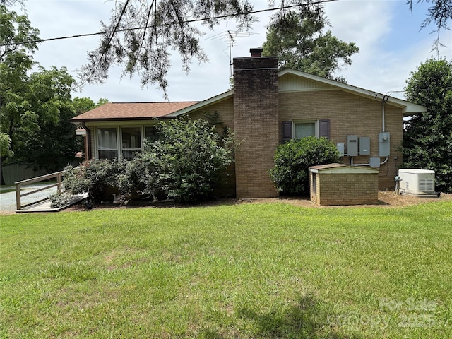 6018 Unionville Rd, Monroe, NC 28110 - view of property exterior featuring brick siding, a chimney, and a lawn