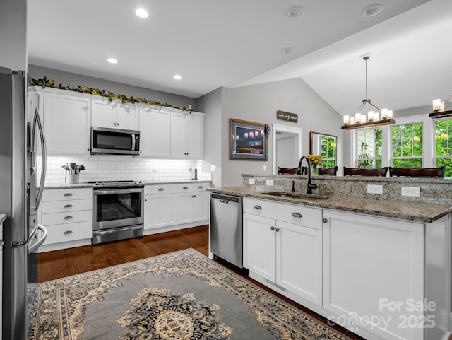 26 Balsam High Rd, Biltmore Lake, NC 28715 - kitchen with appliances with stainless steel finishes, a chandelier, dark wood-style floors, lofted ceiling, and white cabinets