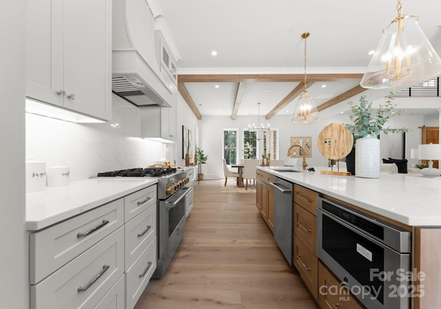 20000 Schooner Dr, Cornelius, NC 28031 - kitchen with a chandelier, stainless steel appliances, custom exhaust hood, a sink, and beam ceiling