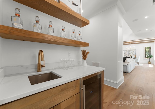20000 Schooner Dr, Cornelius, NC 28031 - indoor wet bar with wine cooler, light wood finished floors, recessed lighting, baseboards, and a chandelier