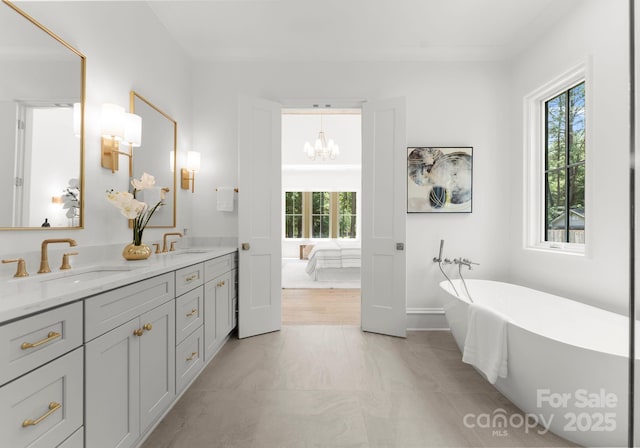 20000 Schooner Dr, Cornelius, NC 28031 - ensuite bathroom with plenty of natural light, double vanity, a soaking tub, and a chandelier