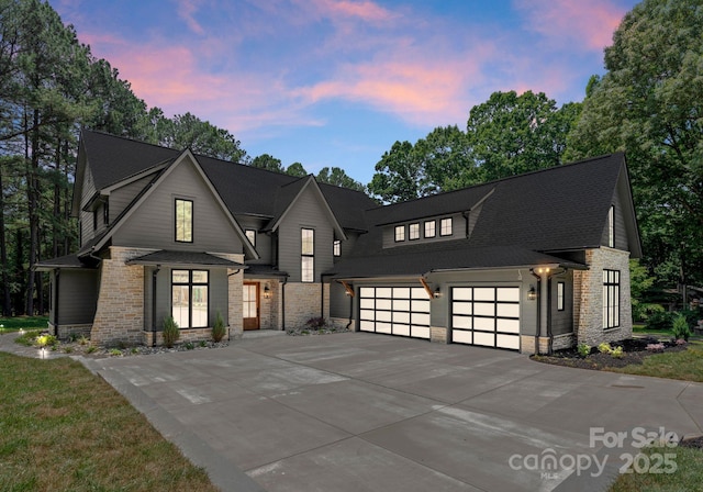 20000 Schooner Dr, Cornelius, NC 28031 - modern farmhouse style home featuring stone siding, driveway, a garage, and roof with shingles