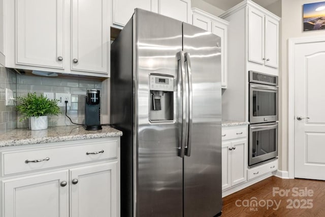 1467 Tranquility Blvd, Lancaster, SC 29720 - kitchen featuring stainless steel appliances, dark wood-style flooring, white cabinetry, decorative backsplash, and light stone counters
