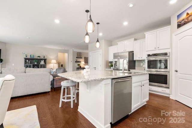 1467 Tranquility Blvd, Lancaster, SC 29720 - kitchen with stainless steel appliances, a sink, a kitchen island with sink, white cabinets, and recessed lighting