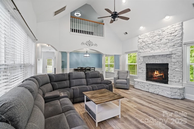 1009 Jerry Ln, Matthews, NC 28105 - living area with arched walkways, ornate columns, high vaulted ceiling, a ceiling fan, and wood finished floors
