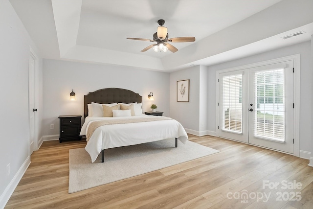 1009 Jerry Ln, Matthews, NC 28105 - bedroom featuring a tray ceiling, access to outside, french doors, and light wood-type flooring