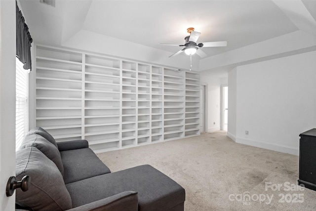 1009 Jerry Ln, Matthews, NC 28105 - unfurnished living room with ceiling fan, a tray ceiling, and carpet floors